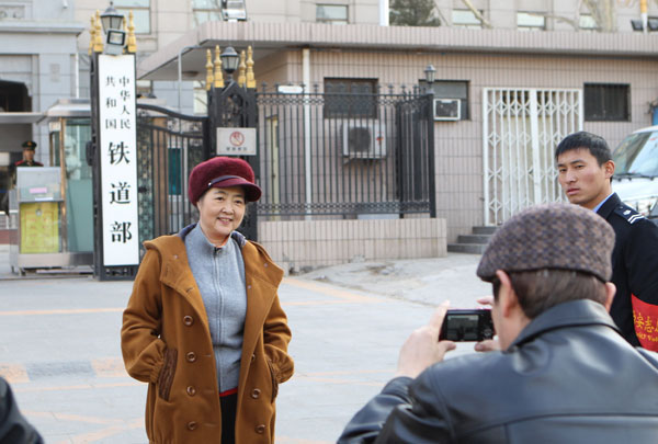 Staff members take photographs at the entrance of the Ministry of Railways, which will be dissolved. Zhu Xingxin / China Daily Reforms moving with the times