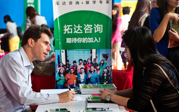 A job seeker (right) talks with a potential employer at a job fair in Beijing in September. The fair was aimed at Chinese students and professionals who had returned from overseas.  More Chinese students return to find work after studying abroad