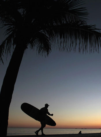 Surfer takes to the water in Rio de Janeiro Surfer takes to the water in Rio de Janeiro
